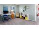 Bright loft area provides a versatile space with carpeting, a window, desk, chair, and shelving unit at 9690 E 5Th Ave, Denver, CO 80230