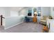 Inviting loft featuring plush carpeting, natural light, a comfortable chair, and a functional desk area at 9690 E 5Th Ave, Denver, CO 80230