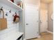 Functional mud room with built-in storage, shiplap accents, hooks, and easy access to the home's entrance at 9690 E 5Th Ave, Denver, CO 80230