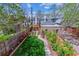 Well-maintained backyard with lush green lawn, tidy garden beds, and a charming brick building at 761 N Lafayette St, Denver, CO 80218
