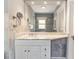 Elegant bathroom featuring a marble countertop, vanity, and decorative mirror, combining functionality with sophisticated style at 761 N Lafayette St, Denver, CO 80218