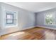 Empty bedroom with hardwood floors, two large windows, and neutral paint, creating a blank canvas to imagine the possibilities at 761 N Lafayette St, Denver, CO 80218