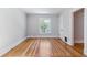 Empty bedroom with hardwood floors, a large window, and neutral paint, creating a blank canvas to imagine the possibilities at 761 N Lafayette St, Denver, CO 80218