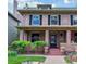 Charming two-story brick home featuring a cozy front porch and well-manicured lawn at 761 N Lafayette St, Denver, CO 80218