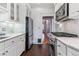 Modern kitchen featuring marble countertops, stainless steel appliances, and ample cabinet space at 761 N Lafayette St, Denver, CO 80218