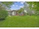 Expansive backyard showcasing a well-maintained lawn, mature trees, and a covered patio for outdoor enjoyment at 2871 Humboldt Cir, Longmont, CO 80503