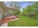 Spacious backyard with a covered patio, perfect for outdoor dining and relaxation, surrounded by beautiful landscaping at 2871 Humboldt Cir, Longmont, CO 80503