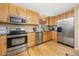 Modern kitchen with stainless steel appliances, light wood cabinets and a granite countertop at 2871 Humboldt Cir, Longmont, CO 80503