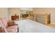 Open-concept living area with railing and neutral walls leading to a dining space at 2871 Humboldt Cir, Longmont, CO 80503