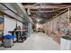 Unfinished basement with exposed beams and brick walls, offering potential for customization and additional living space at 701 W 6Th Ave, Denver, CO 80204