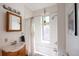 Bright bathroom with a shower-tub combo, white tile, and a decorative window at 701 W 6Th Ave, Denver, CO 80204