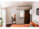 Bedroom featuring an open door to a balcony, wood floors, and a floor mirror at 701 W 6Th Ave, Denver, CO 80204