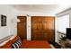 Bedroom with a large window, hardwood floors, and wood closet doors at 701 W 6Th Ave, Denver, CO 80204