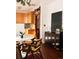 Sunny dining area with hardwood floors, a modern table, and a view into the kitchen at 701 W 6Th Ave, Denver, CO 80204