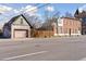 Street view of a home with a brick exterior and an oversized garage, blending urban charm with practicality at 701 W 6Th Ave, Denver, CO 80204