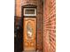 Charming wood front door with decorative oval glass detail and brick surround at 701 W 6Th Ave, Denver, CO 80204