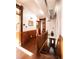 Hallway with wood paneled walls, hardwood floors, skylight, and decorative trim at 701 W 6Th Ave, Denver, CO 80204