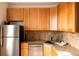 Modern kitchen with stainless steel appliances, stone countertops and light wood cabinetry at 701 W 6Th Ave, Denver, CO 80204