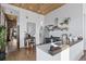 Modern kitchen features stainless steel appliances, open shelving, and hardwood floors at 701 W 6Th Ave, Denver, CO 80204