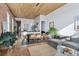 Spacious living room features hardwood floors, brick walls, wood ceiling, and large windows at 701 W 6Th Ave, Denver, CO 80204