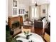 Sunlit living room boasts a cozy fireplace, hardwood floors, and large windows at 701 W 6Th Ave, Denver, CO 80204