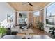 Comfortable living room with exposed brick, wood ceiling, and large windows at 701 W 6Th Ave, Denver, CO 80204