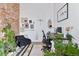 Bright office space with exposed brick walls, plants, and a modern desk, perfect for working from home at 701 W 6Th Ave, Denver, CO 80204