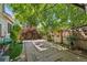 Private backyard featuring a stone patio area, mature trees, and tasteful landscaping at 8060 Meadowdale Sq, Niwot, CO 80503