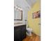 Bright bathroom with a wooden framed mirror, marble countertops, and a black vanity at 8060 Meadowdale Sq, Niwot, CO 80503