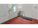 Simple room with red carpet and a treadmill in front of a bright window at 8060 Meadowdale Sq, Niwot, CO 80503