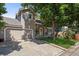 Charming two-story home with a well-maintained front yard, an attached garage, and mature shade trees at 8060 Meadowdale Sq, Niwot, CO 80503