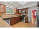 Modern kitchen with stainless steel appliances, granite countertops, and hardwood flooring at 8060 Meadowdale Sq, Niwot, CO 80503