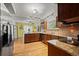 Well-appointed kitchen with granite countertops, stainless steel appliances, and dark wood cabinetry at 8060 Meadowdale Sq, Niwot, CO 80503