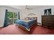 Bright main bedroom featuring hardwood floors, a king bed, and access to a balcony at 8060 Meadowdale Sq, Niwot, CO 80503