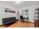 Home office area with built in shelving, large picture window, and a couch at 8060 Meadowdale Sq, Niwot, CO 80503