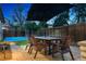 A beautiful patio area with a picnic table with a basketball court in the background at 2500 S Clayton St, Denver, CO 80210
