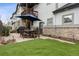 This backyard has a basketball court, stone patio, and grill, which is perfect for entertainment and relaxation at 2500 S Clayton St, Denver, CO 80210