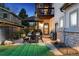 Cozy backyard patio with a stone exterior, umbrella-covered table, and grill, ideal for outdoor dining at 2500 S Clayton St, Denver, CO 80210