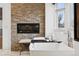 Tranquil bathroom with freestanding tub, modern fireplace, and stone accent wall at 2500 S Clayton St, Denver, CO 80210