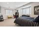 A stylish bedroom with large windows, dark furniture, and neutral carpet at 2500 S Clayton St, Denver, CO 80210