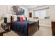 Cozy bedroom with comfortable bed, and neutral decor. The room features an interesting art collection at 2500 S Clayton St, Denver, CO 80210