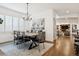 An elegant dining room with modern chandelier and decor, hardwood floors, and neutral colors at 2500 S Clayton St, Denver, CO 80210