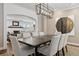 Stylish dining room featuring a modern chandelier and neutral decor, with a glimpse into the cozy living room at 2500 S Clayton St, Denver, CO 80210