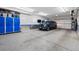 Well-organized garage featuring epoxy floors, custom storage cabinets, and parking space for a SUV at 2500 S Clayton St, Denver, CO 80210