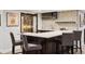 This stylish home bar features a wine refrigerator, a marble countertop, and comfortable seating at 2500 S Clayton St, Denver, CO 80210