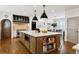 Spacious kitchen boasts a large island, stylish pendant lighting, stainless steel appliances, and a butler's pantry at 2500 S Clayton St, Denver, CO 80210