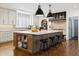 Spacious kitchen boasts a large island, stylish pendant lighting, stainless steel appliances, and ample counter space at 2500 S Clayton St, Denver, CO 80210