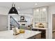 Gourmet kitchen featuring an island, bar with wine cooler, and open layout into the living room and staircase at 2500 S Clayton St, Denver, CO 80210