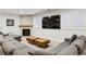 A comfy living room features a stone fireplace, large TV, and sectional sofa perfect for relaxation at 2500 S Clayton St, Denver, CO 80210
