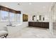 A spa-like bathroom featuring a freestanding tub, double vanities, and decorative tile at 2500 S Clayton St, Denver, CO 80210